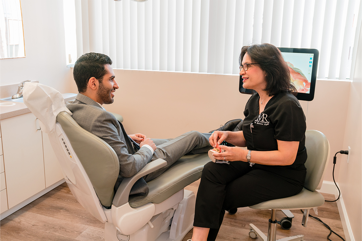 A patient talking to the doctor about full mouth reconstruction in Los Angeles.