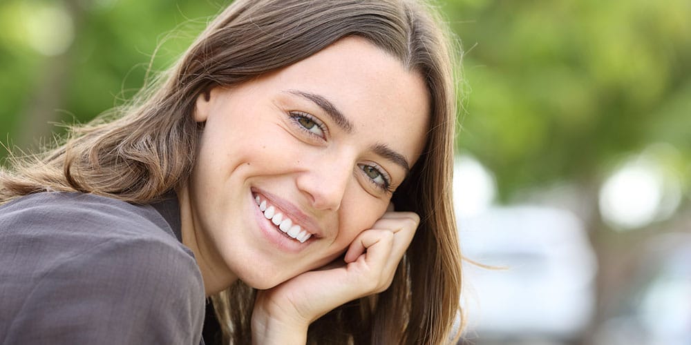 woman smiling after getting dental crowns in Beverly Hills