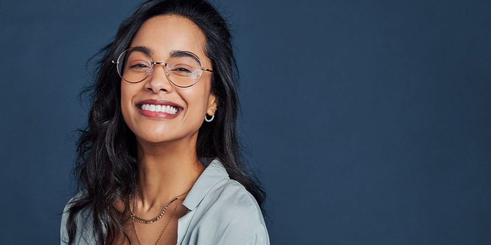 woman smiling after getting a bone graft for dental implants in Los Angeles, CA