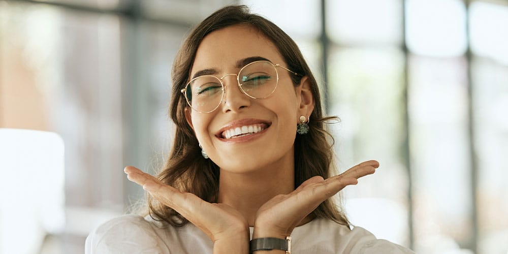 woman smiling after getting full arch implants in Los Angeles, CA