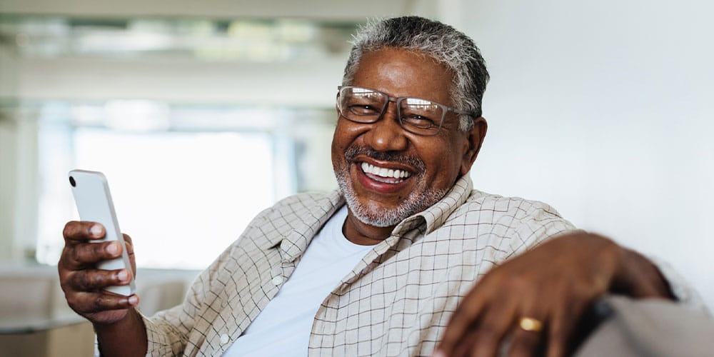 older man smiling after replacing his dentures in Los Angeles, CA