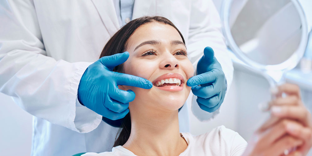 woman smiling at the dentist after getting dental implants in Los Angeles, CA