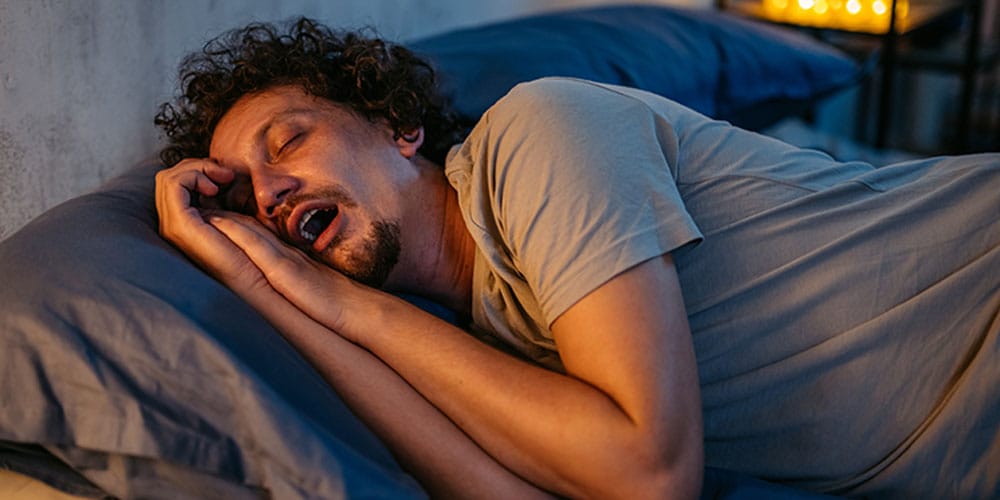 man with sleep apnea snoring while sleeping in Los Angeles, CA