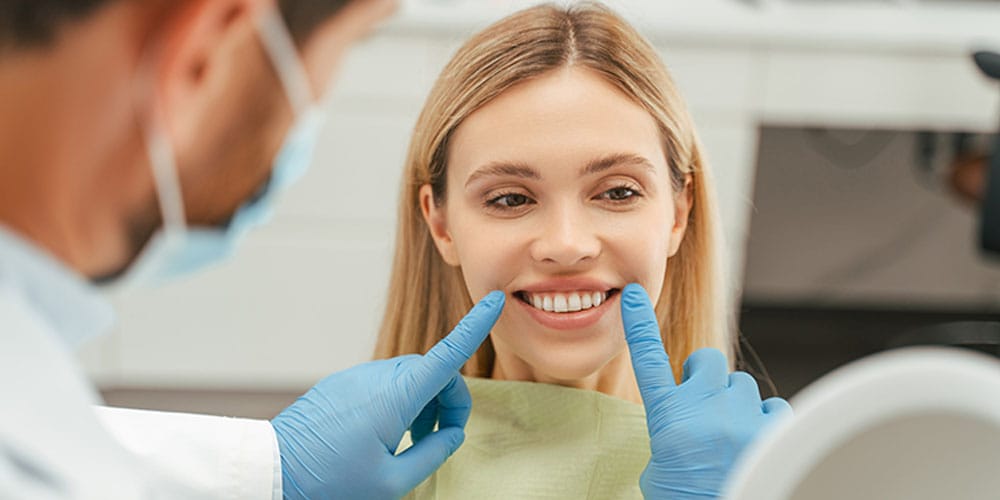 woman smiling at the dentist after getting dental implants in Los Angeles, CA