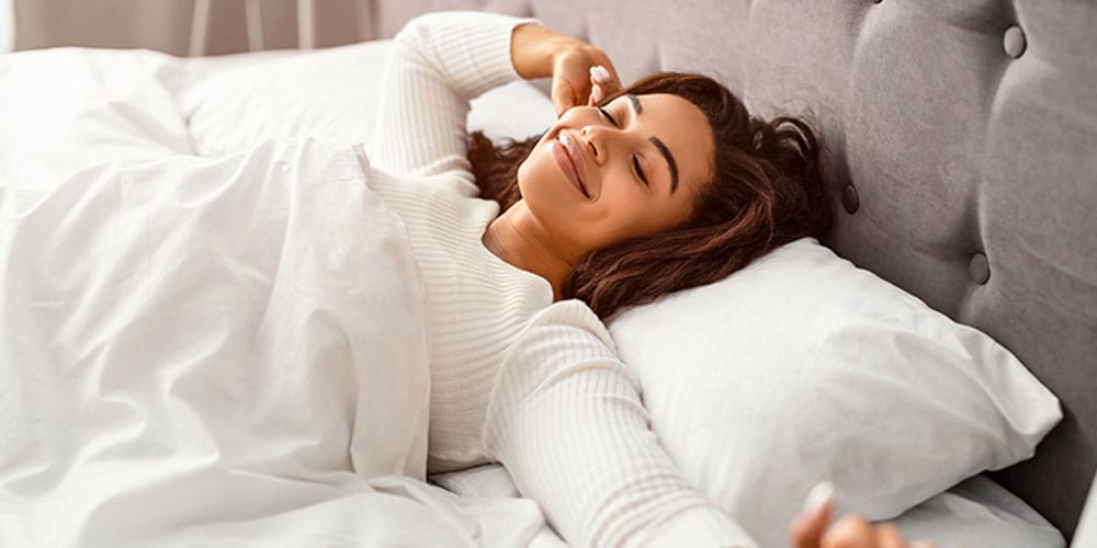woman sleeping after starting oral appliance therapy in Los Angeles, CA